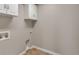 The laundry room has tile floors, overhead cabinets, and hookups at 7665 Grady Cir, Castle Rock, CO 80108