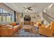 Bright living room features hardwood floors, ceiling fan, and comfortable leather furniture at 7665 Grady Cir, Castle Rock, CO 80108