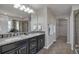 Main bathroom featuring dual sinks, granite countertops, and a tiled shower at 7665 Grady Cir, Castle Rock, CO 80108