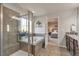 Serene main bathroom with a bathtub, tiled shower, and an entrance to the main bedroom at 7665 Grady Cir, Castle Rock, CO 80108