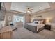Comfortable main bedroom with neutral tones, a tray ceiling, and a cozy chair at 7665 Grady Cir, Castle Rock, CO 80108