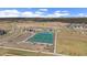Aerial view of community tennis courts, pool, and playground at 14268 Hop Clover Trl, Parker, CO 80134