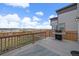 This back deck includes a grill, wood railings, and neighborhood views at 14268 Hop Clover Trl, Parker, CO 80134