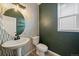 Stylish powder room with unique wall decor, pedestal sink, and modern fixtures at 14268 Hop Clover Trl, Parker, CO 80134