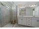 Contemporary bathroom with a glass shower and double vanity with sleek fixtures at 14268 Hop Clover Trl, Parker, CO 80134