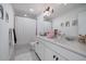 Bathroom features a double vanity, bright lighting, and modern fixtures at 14268 Hop Clover Trl, Parker, CO 80134