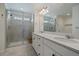 Modern bathroom with double vanity, quartz countertops, and a large glass-enclosed shower at 14268 Hop Clover Trl, Parker, CO 80134