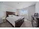 This primary bedroom features a plush rug, a window, and stylish dark wood furnishings at 14268 Hop Clover Trl, Parker, CO 80134