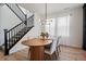 Dining room with a stylish light fixture, view of the stairway, and ample natural light at 14268 Hop Clover Trl, Parker, CO 80134
