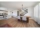 Dining room with a modern light fixture and hardwood floors, leading into the kitchen area at 14268 Hop Clover Trl, Parker, CO 80134