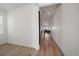 Hallway with hardwood floors, white walls, leading into open floor plan living space at 14268 Hop Clover Trl, Parker, CO 80134