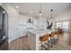 Bright kitchen with white cabinets, stainless appliances, and a center island open to the dining area at 14268 Hop Clover Trl, Parker, CO 80134