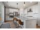 Modern kitchen with stainless steel appliances, a large island, and stylish pendant lighting at 14268 Hop Clover Trl, Parker, CO 80134