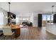 Spacious living room with modern fireplace, hardwood floors, and access to the outdoor patio at 14268 Hop Clover Trl, Parker, CO 80134