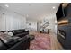 Open-concept living space with fireplace, hardwood floors, and seamless connection to the kitchen at 14268 Hop Clover Trl, Parker, CO 80134