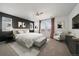 Serene main bedroom featuring a neutral palette, accent wall, and large windows at 14268 Hop Clover Trl, Parker, CO 80134