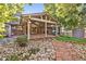 Landscaped backyard with patio, rock pathway, and shed at 2695 S Ammons Way, Lakewood, CO 80227