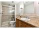 Bathroom with shower, tile flooring and wood vanity at 2695 S Ammons Way, Lakewood, CO 80227