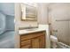 Bathroom with light wood vanity and updated fixtures at 2695 S Ammons Way, Lakewood, CO 80227