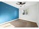 Bright bedroom with blue accent wall and carpet flooring at 2695 S Ammons Way, Lakewood, CO 80227