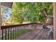 Wooden deck overlooks a fenced backyard with trees at 2695 S Ammons Way, Lakewood, CO 80227