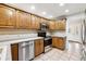 Kitchen boasts stainless steel appliances and wood cabinetry at 2695 S Ammons Way, Lakewood, CO 80227