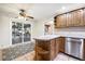 Eat-in kitchen with wood cabinets, access to backyard, and tile floor at 2695 S Ammons Way, Lakewood, CO 80227