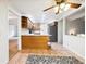 Kitchen with wood cabinets, an island, and tile floor at 2695 S Ammons Way, Lakewood, CO 80227