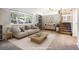 Virtually staged living room with built-in shelving and stairs at 2695 S Ammons Way, Lakewood, CO 80227