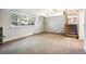 Living room with built-in shelving and staircase to upper level at 2695 S Ammons Way, Lakewood, CO 80227