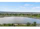 Beautiful aerial view showcasing a peaceful lake surrounded by lush green trees and a vibrant cityscape beyond at 4712 Perry St, Denver, CO 80212