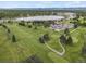 Stunning aerial view of the golf course with a lake, clubhouse, and ample parking at 4712 Perry St, Denver, CO 80212