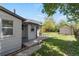 A serene backyard with a lush lawn, a patio with seating, and a storage shed at 4712 Perry St, Denver, CO 80212
