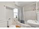 Bathroom featuring shower-tub combo, white fixtures, and a built-in medicine cabinet at 4712 Perry St, Denver, CO 80212