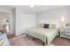 Well-lit bedroom featuring a queen-size bed, soft rug, and a closet at 4712 Perry St, Denver, CO 80212