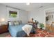 Comfortable bedroom with large windows, desk, and a decorative patterned rug at 4712 Perry St, Denver, CO 80212