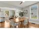 Bright dining room open to living room, featuring hardwood floors and large windows overlooking the exterior at 4712 Perry St, Denver, CO 80212