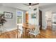 Well-lit dining area featuring hardwood floors and seamless flow to other living spaces at 4712 Perry St, Denver, CO 80212