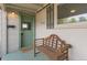 Inviting front porch features a comfortable wooden bench and charming 'Welcome' mat at 4712 Perry St, Denver, CO 80212