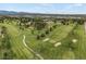 Picturesque aerial view of a lush green golf course with sand traps and mature trees at 4712 Perry St, Denver, CO 80212