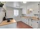Functional kitchen with ample counter space, white cabinets, and modern gas range at 4712 Perry St, Denver, CO 80212