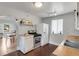 Efficient kitchen with white appliances, gas range, and vintage tile flooring at 4712 Perry St, Denver, CO 80212