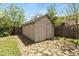 Storage shed with double doors, adjacent to fenced yard and greenery at 4712 Perry St, Denver, CO 80212