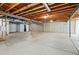 Unfinished basement with exposed wood ceiling and cement walls, offering potential for customization at 7426 E 148Th Pl, Thornton, CO 80602