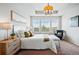 Comfortable bedroom with a sitting area, a chandelier, and large windows offering scenic views at 7426 E 148Th Pl, Thornton, CO 80602