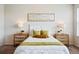 Inviting bedroom with stylish nightstands, lamps, and a decorative painting above the headboard at 7426 E 148Th Pl, Thornton, CO 80602