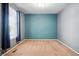 Bedroom featuring gray and teal walls, neutral carpet, a window, and a ceiling light at 7426 E 148Th Pl, Thornton, CO 80602