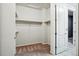 Empty walk-in closet features ample shelving, with an open door that leads to the hall at 7426 E 148Th Pl, Thornton, CO 80602