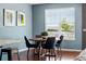 Cozy dining area with hardwood floors, modern lighting, and a large window at 7426 E 148Th Pl, Thornton, CO 80602
