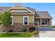 Charming exterior with stone accents, manicured lawn and inviting front porch at 7426 E 148Th Pl, Thornton, CO 80602